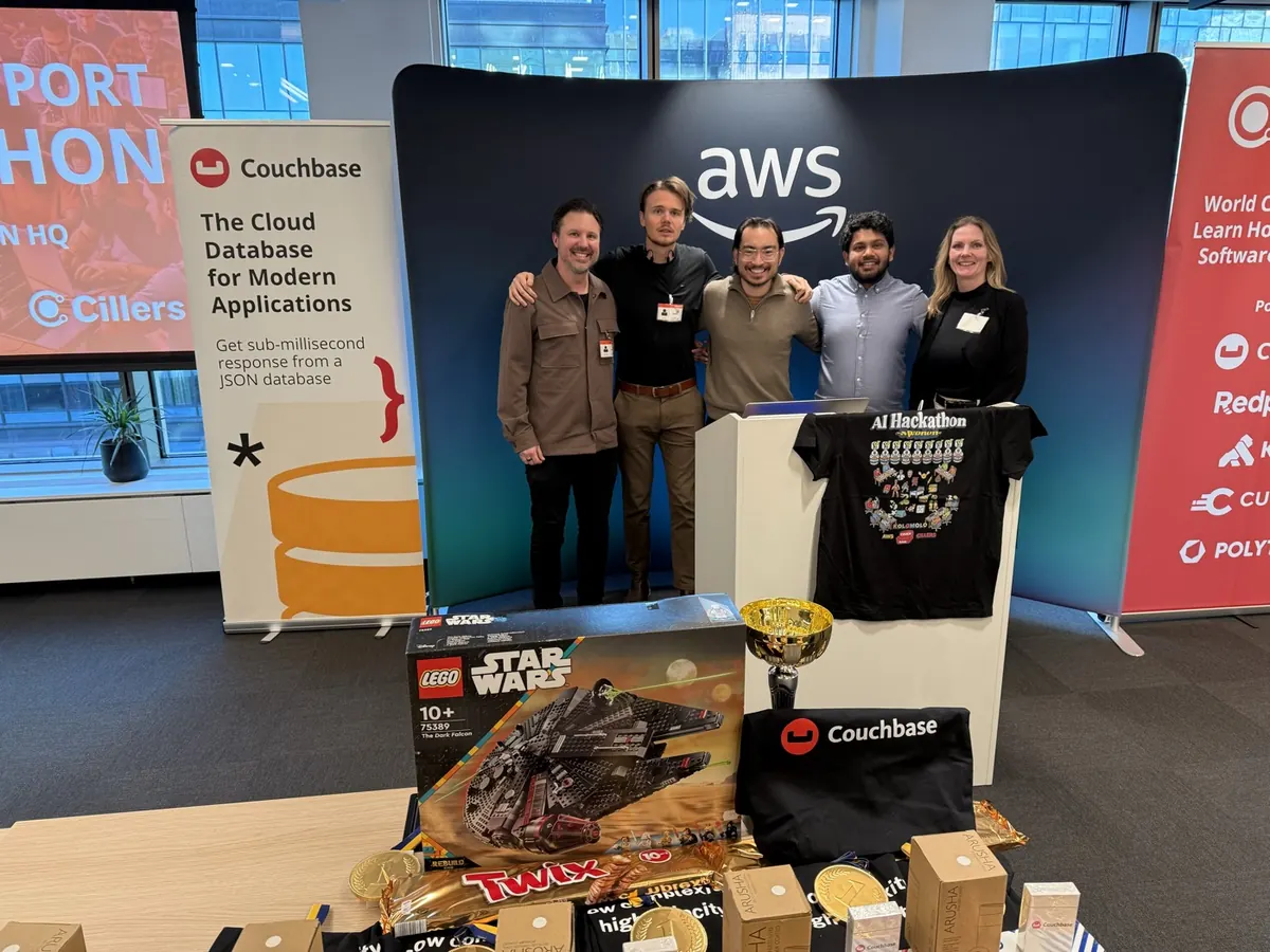 Hackathon team with prizes at an AI hackathon hosted at AWS
